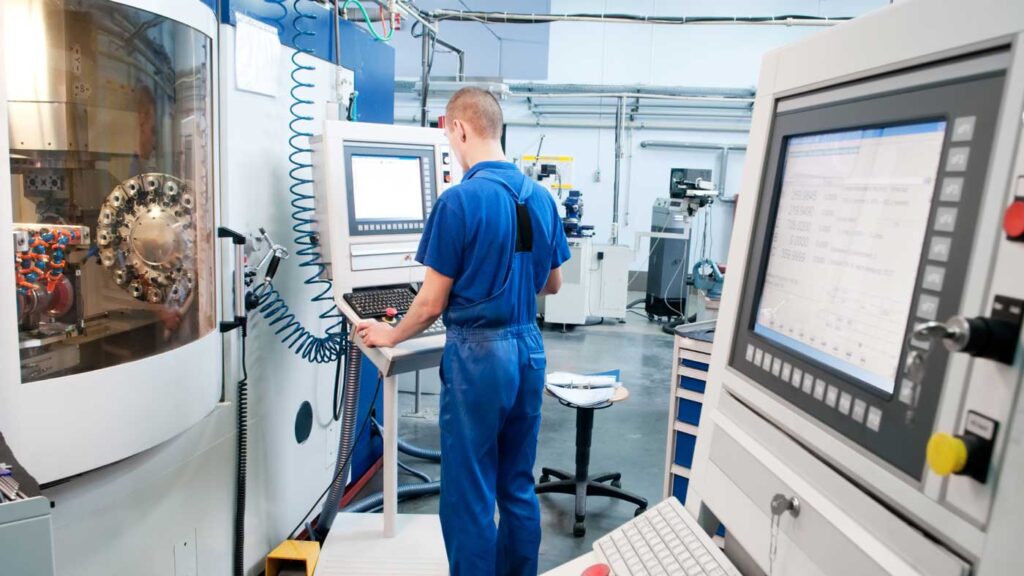 Worker operating CNC machine center